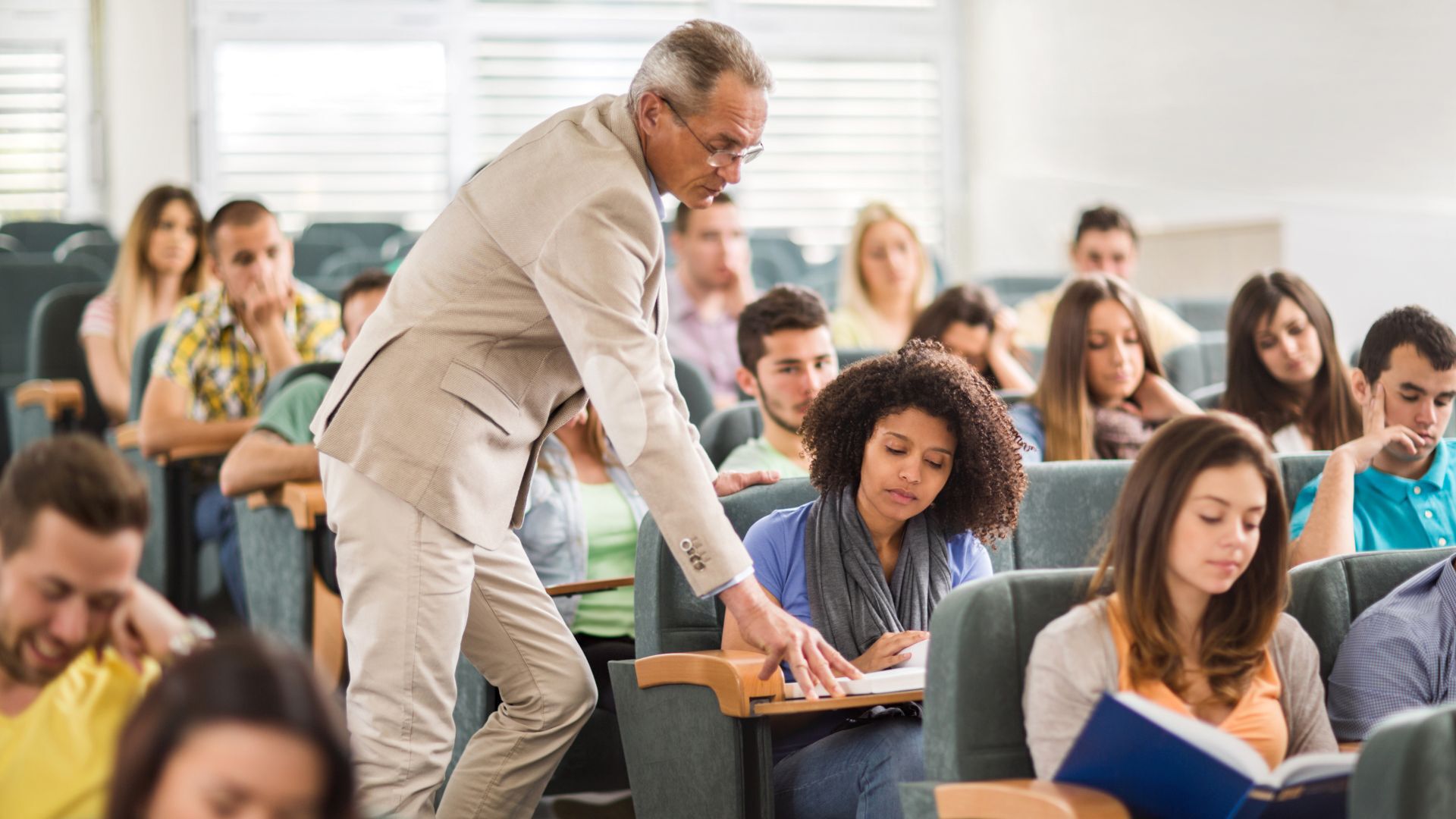 Male professor helping female student with her school work